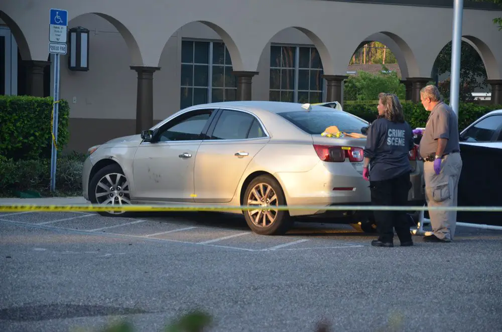Detectives and crime scene investigators were processing the vehicle--in which the two victims were shot--at Palm Coast Fire Station 25 this morning. The vehicle was bullet-ridden from behind. (c FlaglerLive)