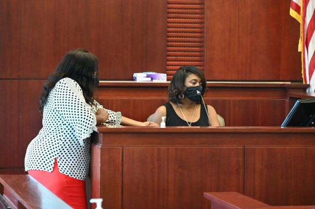 Carmen Gray addressing the court today as her sister held her hand. (© FlaglerLive)