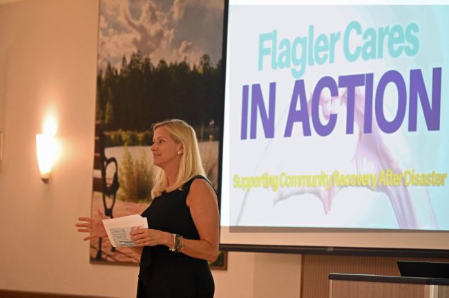 The expo was made possible with a Red Cross grant secured by Flagler Cares for Flagler Volunteer Services. Flagler Cares' Carrie Baird spoke to the audience Tuesday. (© FlaglerLive)