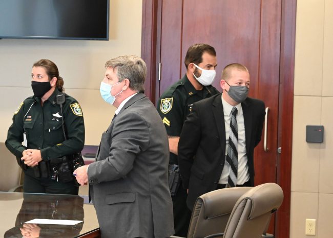 Joshua Carver's bond was revoked and he was returned to the Flagler County jail. His attorney, Bill Bookhammer, is to the left. (© FlaglerLive)