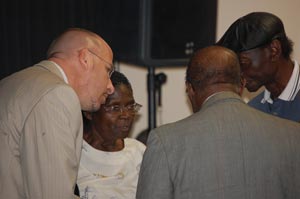 The huddle before the meeting: Carver Gym advocates, from left, Chris Borgmann, Rev. Daisy Henry, Rev. Frank Giddens and Aaron McKinney (FlaglerLive)