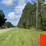 The tip of the required sign announcing the coming hearing before the Palm Coast Planning Board on the land use changes that would enable the development of up to 850 residential homes and apartments on acres off of Seminole Woods Boulevard. (Palm Coast)