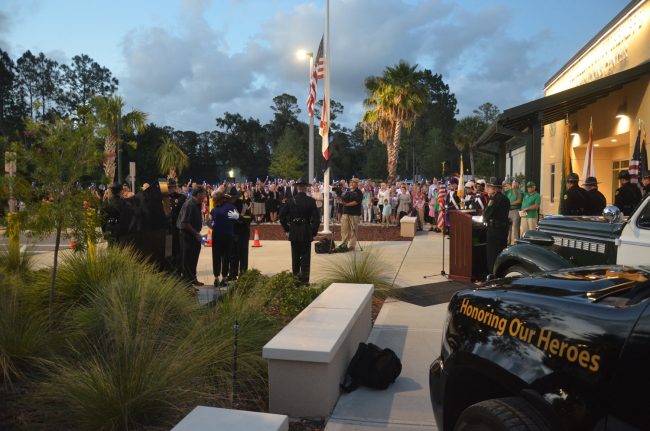 The Sheriff embraces Sgt. Frank Celico's mother in front of the memorial to fallen officers during the remembrance ceremony. Click on the image for larger view. (© FlaglerLive)