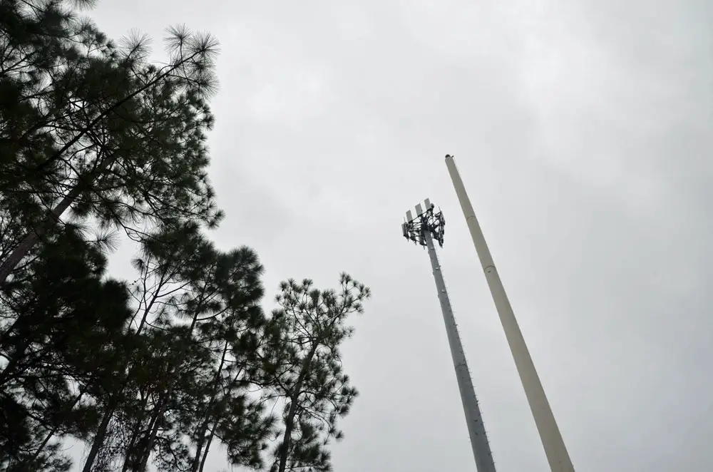 The new cell tower behind the Palm Coast Tennis Center is on the left, next to an existing, but less effective, tower. (© FlaglerLive)