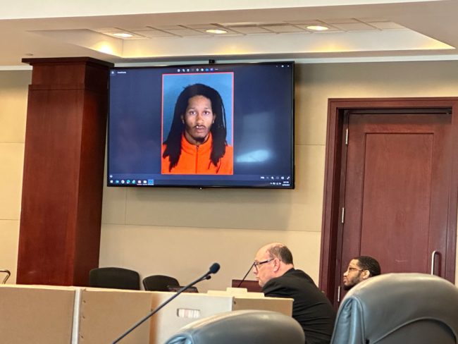 Marcus Chamblin on the screen at the time of the shooting, and in the courtroom, next to his attorney, Terence Lenamon. (© FlaglerLive)