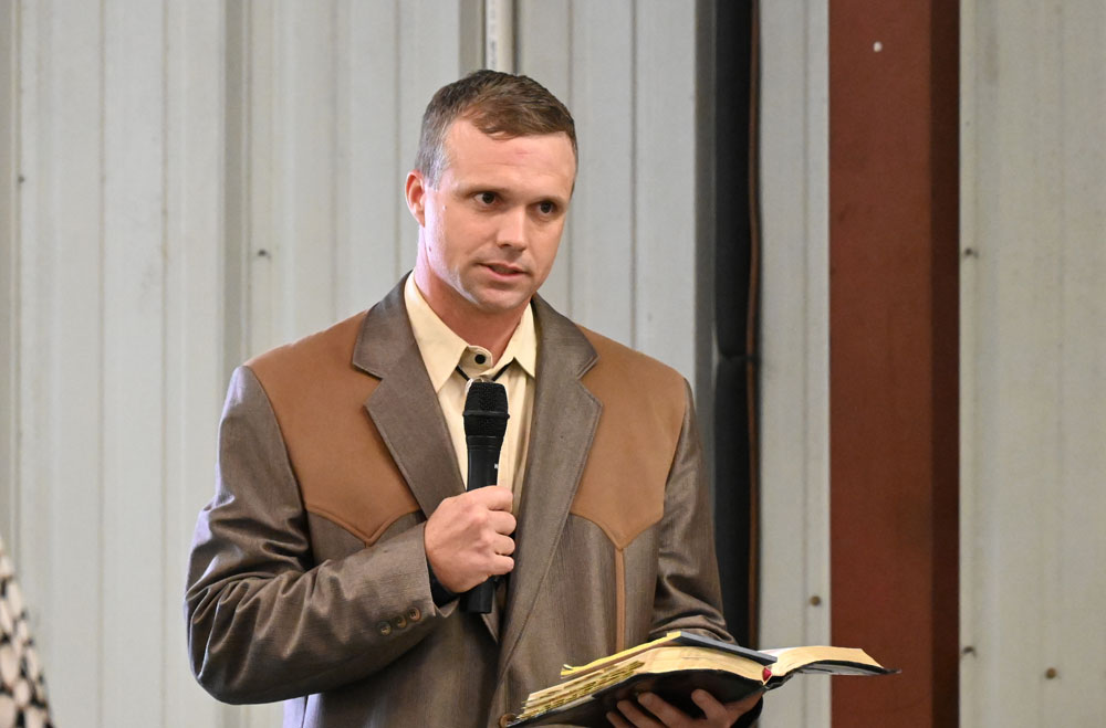 Charles L/ Cowart reading scriptures at a celebration of life for Sisco Deen in September 2023 at Cattleman's Hall at the Flagler County Fairgrounds. Deen had mentored Cowart. (© FlaglerLive)