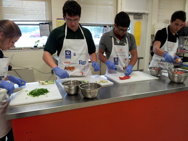 Chefs in the making: Amanda Hale, Dylan Areizaga, Mathew Sousa and Ronnie Stedman preparing food to cater a dinner for the Flagler Palm Coast High School girls weightlifting team. (© FlaglerLive)