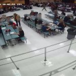 Cheryl Andrews, standing by the left-most table, as she was shoving the student's head, as captured in surveillance footage at Indian Trails Middle School.