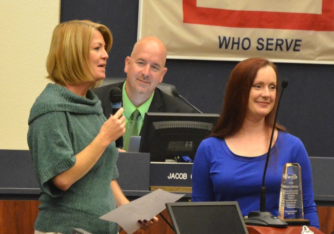 Cheryl Tristam receiving the Power of One award from School Board Chairwoman Colleen Conklin, with Superintendent Jacob Oliva looking on. (© FlaglerLive)