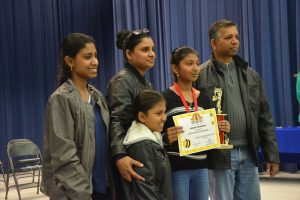 Runner-up Chevaney Chandradat of Belle Terre Elementary and her family. (© FlaglerLive)