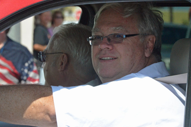 Flagler Beach Fire Chief Martin Roberts, with Commissioner Marshall Shupe, riding together during last year's July 4 parade. (© FlaglerLive)