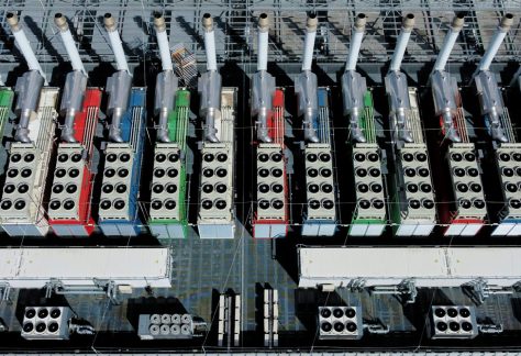 chillers on the roof of a data center from above, work to cool the equipment inside the building.