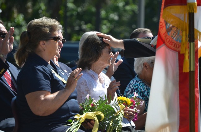 A prayer being offered for the family of Chuck Sease, the last deputy to be killed in the line of duty in Flagler County, in 2004. Click on the image for larger view. (© FlaglerLive)