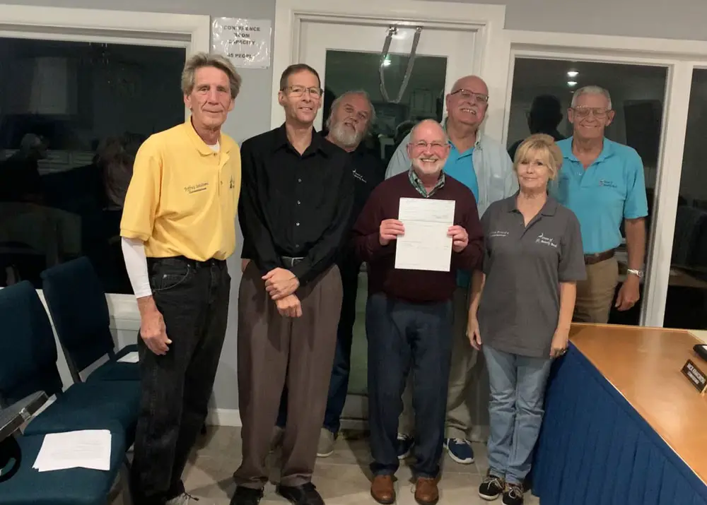 Flagler County Health Department Director Bob Snyder, holding the $10,000 check, a donation from the Town of Beverly Beach. He was flanked by the town commissioners and the mayor at Monday's meeting, when the commission voted to donate the money. (Flagler County Health Department)