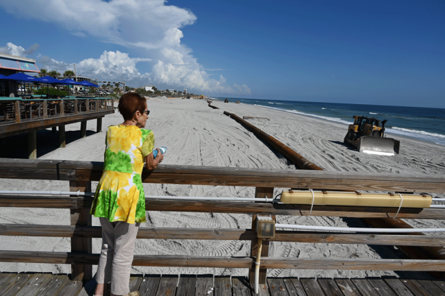 Flagler Beach City Commissioner Jane Mealy looking at the northern portion of the renourishment project from the pier. (© FlaglerLive)