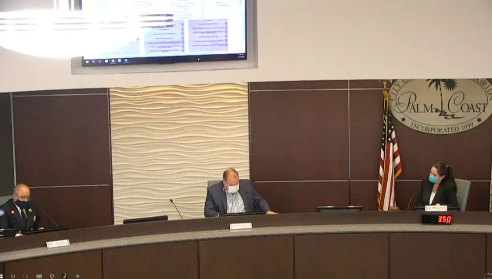 Palm Coast Mayor Milissa Holland, right, with City Manager Matt Morton, center, and Fire Chief Jerry Forte at this afternoon's briefing on the city's phased plan for resuming activities in the city. (© FlaglerLive via Palm Coast's YouTube Channel)