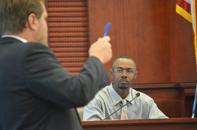 C.J. Nelson answering questions from his attorney, Josh Davis, in court this morning. Nelson faces a felong child abuse charge stemming from a confrontation with a 16-year-old girl at Epic Theater in Palm Coast in  October 2016. (© FlaglerLive)