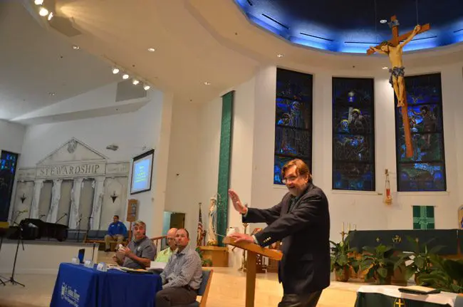 Clay Henderson, the environmental attorney, was the St. Johns River Water Management District's chosen moderator at Wednesday's public-input meeting on a wetlands restoration project. The meeting took place at Santa Maria del Mar Catholic Church. (© FlaglerLive)