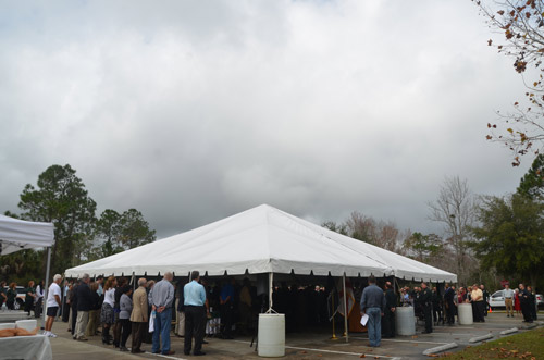 To some, it may have appeared as if the clouds were gathering over the sheriff's office during the swearing in. In fact, the clouds largely dissipated soon after, though skies were nowhere near entirely blue. (© FlaglerLive)