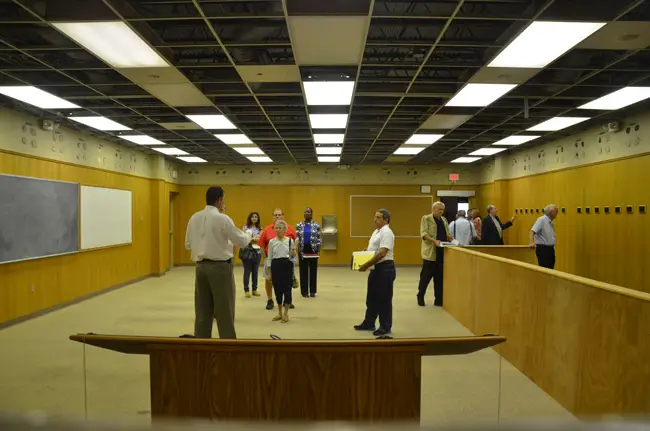 Flagler County Administrator Craig Coffey, with his back to the camera, led a 70-minute tour of the old courthouse Wednesday for members of a committee responsible for recommending how next to proceed with the structure. (© FlaglerLive)