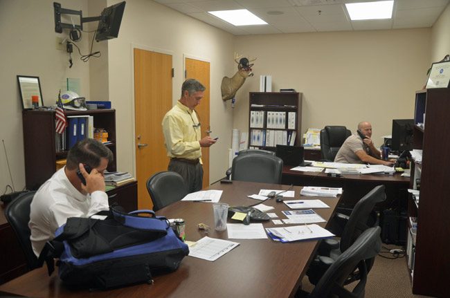 Flagler County's top officials have been focusing on various recovery issues, most notably securing an emergency declaration from FEMA to help individual homeowners. This morning at the Emergency Operations Center, from left, County Administrator Craig Coffey, Property Appraiser Jay Gardner, and Emergency Services Manager Steve Garten. (© FlaglerLive)