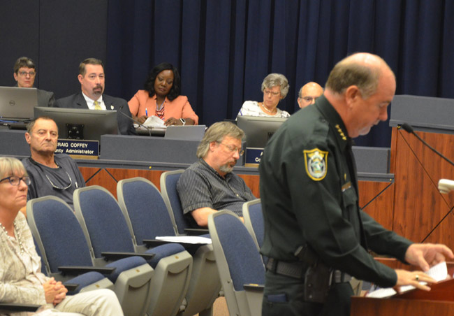 County Administrator Craig Coffey, upper left, sat silent as Sheriff Rick Staly publicly criticized his tenure before county commissioners this morning. Staly stopped short of calling for Coffey's firing or resignation. (© FlaglerLive)