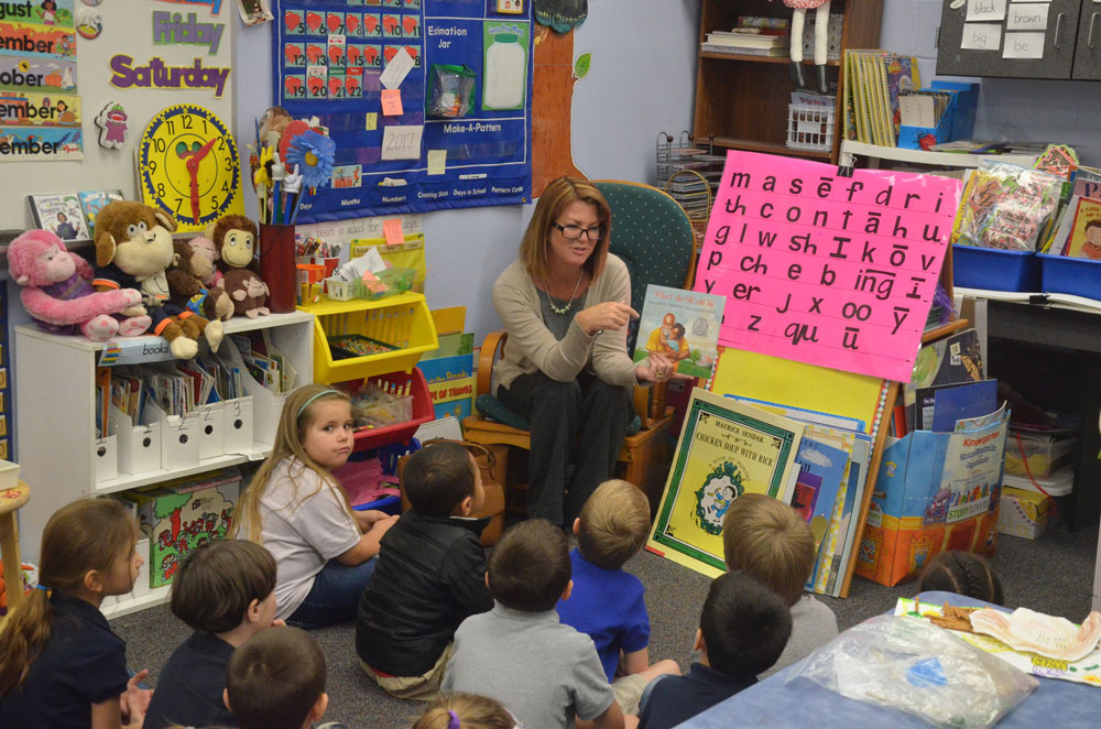 Colleen Conklin, when she was a Flagler County School Board member, reading to children in 2017. (© FlaglerLive)