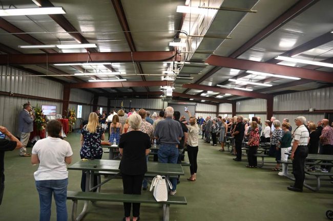 The audience at Cattleman's Hall as the colors are retrieved. (© FlaglerLive)