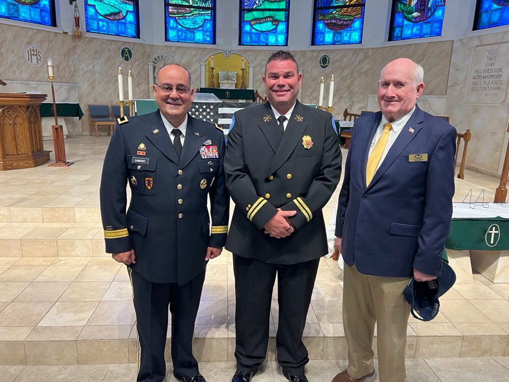 Battalion Chief Gary Potter accepts an award alongside Council Members Charles Gambaro and David Sullivan. (Palm Coast)