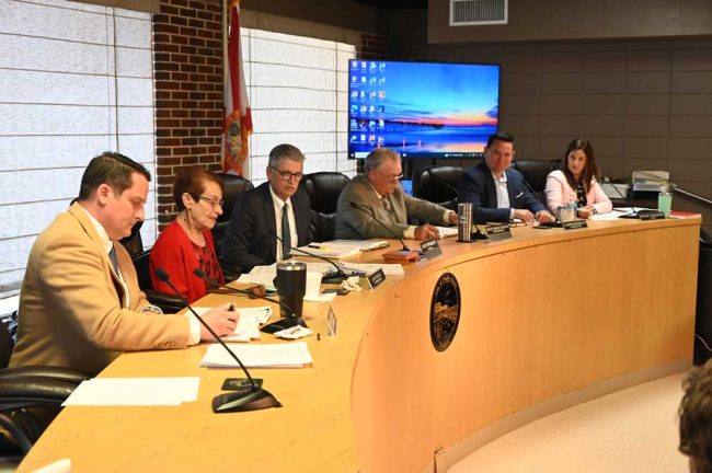 The new commission. From left, Eric Cooley, Jane Mealy, Scott Spradley, Rick Belhumeur, James Sherman and Mayor Suzie Johnston. (© FlaglerLive)