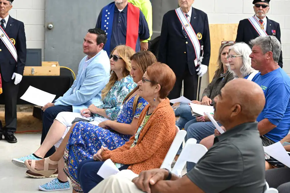 The Flagler Beach City Commission in a less stressful environment, at last April's dedication of a glass-crushing recycling machine. From left, Commissioner James Sherman, Devorah Phillips, Mayor Suzie Johnston, Commissioner Jane Mealy and Commission Chairman Ken Bryan. Commissioner Eric Cooley is not pictured. (© FlaglerLive)