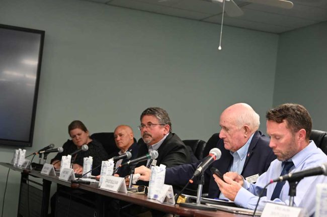 From left, Flagler Beach commissioners Leann Pennington, Donald O'Brien, Andy Dance, who chairs the commission, Greg Hansen, hidden by Dave Sullivan, and Assistant County Attorney Sean Moylan. County Administrator Heidi Petito and Assistant County Administrator Jorge Salinas were also at the table, with two representatives from the Clerk of Court also present. (© FlaglerLive)