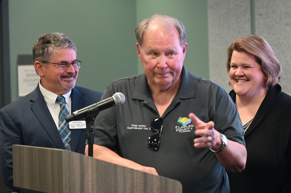 County Commission Chair Andy Dance, left, with Commissioners Greg Hansen and Leann Pennington during their tribute. (© FlaglerLive)