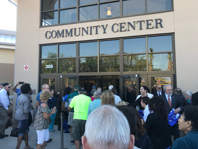 The ribbon-cutting at the renovated Palm Coast Community Center, an $8 million, 13-month project, drew a crowd Friday. (© FlaglerLive)