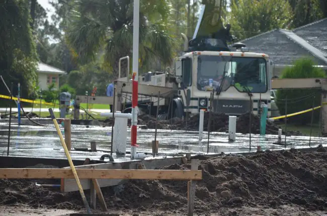 The workers had just finished pouring the duplex's concrete foundations. (© FlaglerLive)