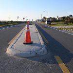 The concrete median that divides State Road A1A starts at South 9th Street, where the motorcyclist attempted to pass an SUV on the left, striking the median and overturning. (© FlaglerLive)