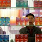 A Chinese visitor looks at condoms at the Beijing International Sex Supplies Exhibition.