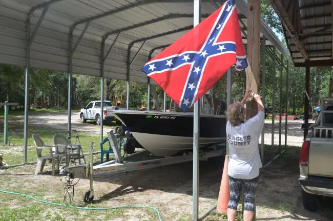 'I don’t go around advertising that flag, I don’t go around advertising nothing.' Gail Durrance said, taking down the Confederate flag she flew at the Princess Place Preserve, against a 'barn' used by county employees for their park vehicles and equipment. (© FlaglerLive)