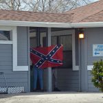Teens brandished a confederate flag on the grounds of the city's Freeda Zamba pool Sunday afternoon, next to Belle Terre Park, where bigoted and obscene graffiti had been spray-painted. (© FlaglerLive)