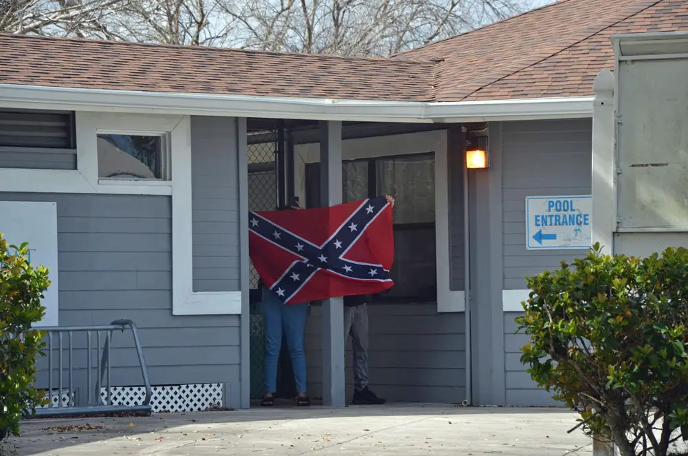 Teens brandished a confederate flag on the grounds of the city's Freeda Zamba pool Sunday afternoon, next to Belle Terre Park, where bigoted and obscene graffiti had been spray-painted. (© FlaglerLive)