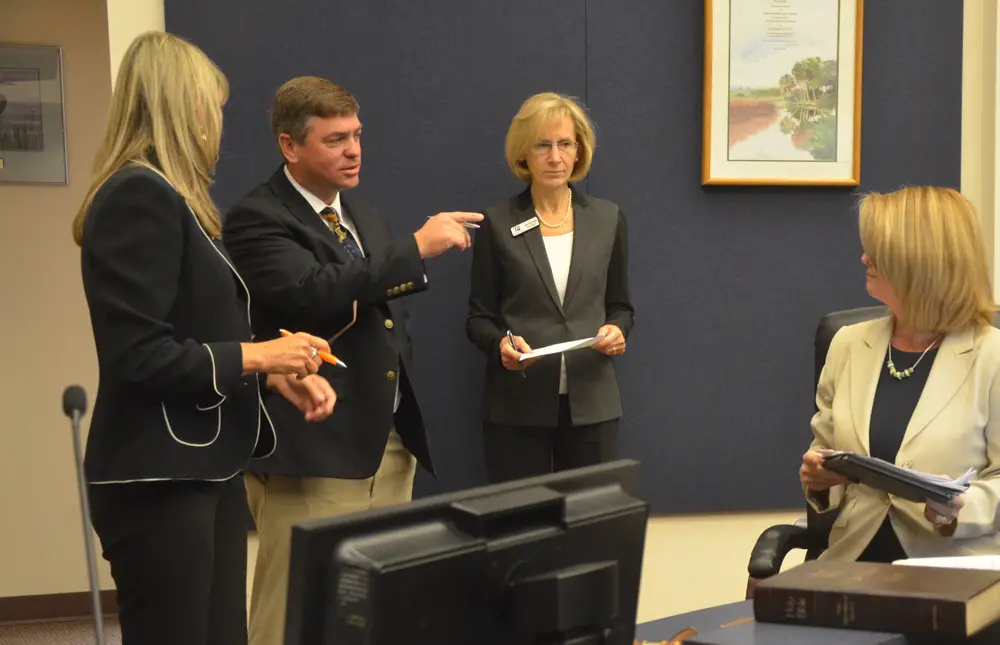 Flagler County School Board members will see less of Colleen Conklin over the next few weeks as they consider the appointment to the superintendent post, for which she is a candidate. From left, Maria Barbosa, Trevor Tucker, Janet McDonald and Conklin after Conklin was last sworn in, in 2016. (© FlaglerLive)