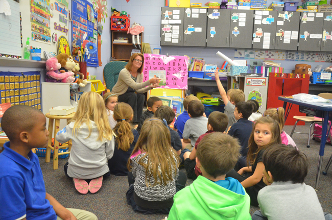 It pays off: School Board member Colleen Conklin reading to students at Belle Terre Elementary earlier this year. (c FlaglerLive)