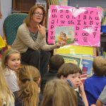 School Board member Colleen Conklin reading to students at Belle Terre Elementary School. (© FlaglerLive)