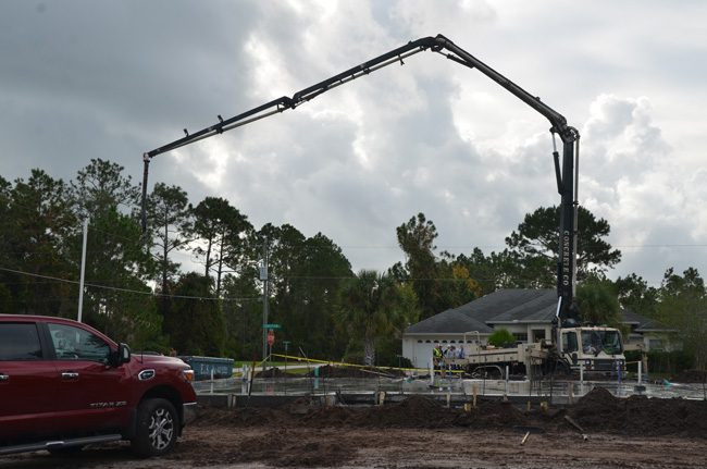 The truck's boom struck a power line, severing it and electrocuting two construction workers this morning. (c FlaglerLive)