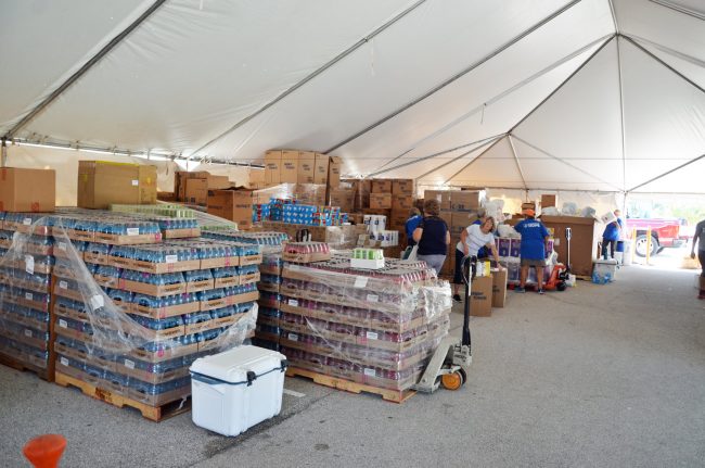 The relief stocks under Convoy of Hope's big tent at Santa Maria del Mar Church's parking lot. Click on the image for larger view. (© FlaglerLive)