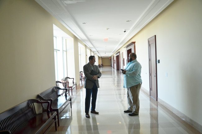 Eric Cooley, left, speaking with News-Journal report Matt Bruce this morning outside the courtroom, just after the charge against Cooley was dropped. (© FlaglerLive)