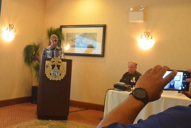 Corey Miller, who described himself as a perpetrator and a victim of domestic violence across generations, was among the speakers at today's summit at the Hilton Garden Inn. The summit was convened by Sheriff Rick Staly, right. (© FlaglerLive)