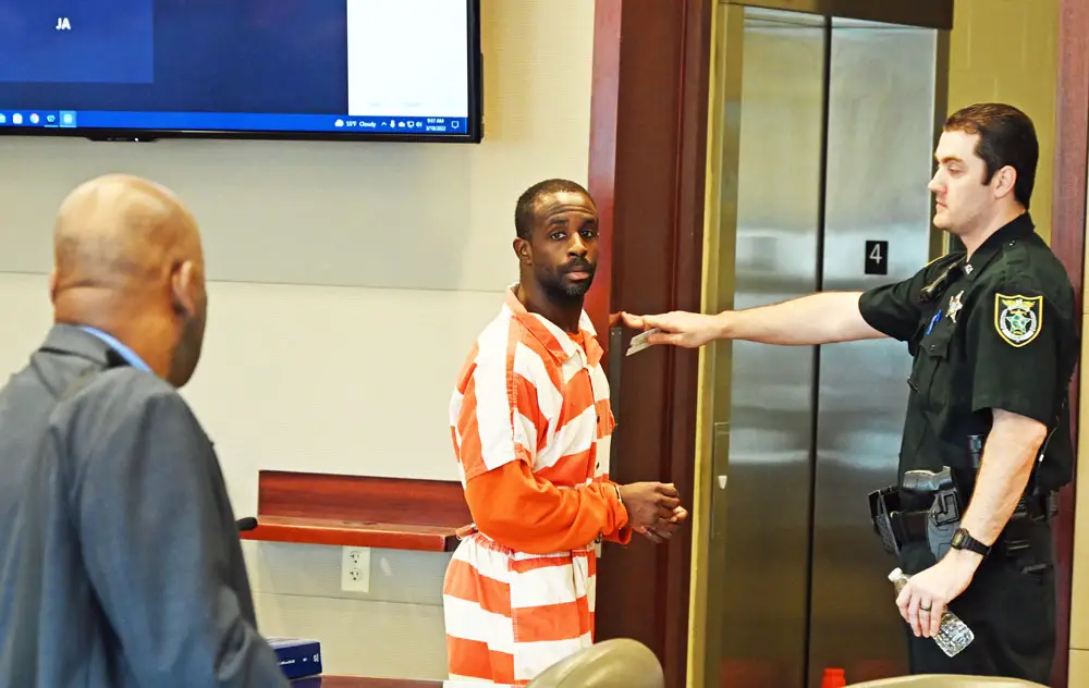 Cornelius Baker moments after he learned that his life would be spared, following a five-minute sentencing hearing this morning in Circuit Court in Bunnell. His attorney, Junior Barrett, is to the left. (© FlaglerLive)