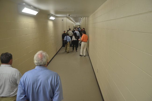 The gas leak was traced to water heaters stored in a room behind this long corridor at the Flagler County jail, which connects the old portion of the jail with the new. The corridor is seen here during last July's open house, before inmates were moved into the newer portion of the jail.l (© FlaglerLive)