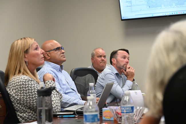 The county's team, looking at a site plan for Hammock Harbor as it appeared on an overhead screen. From left, County Administrator Heidi Petito, Deputy County Administrator Jorge Salinas, Assistant County Attorney Sean Moylan, and Planning Director Adam Mengel. (© FlaglerLive)